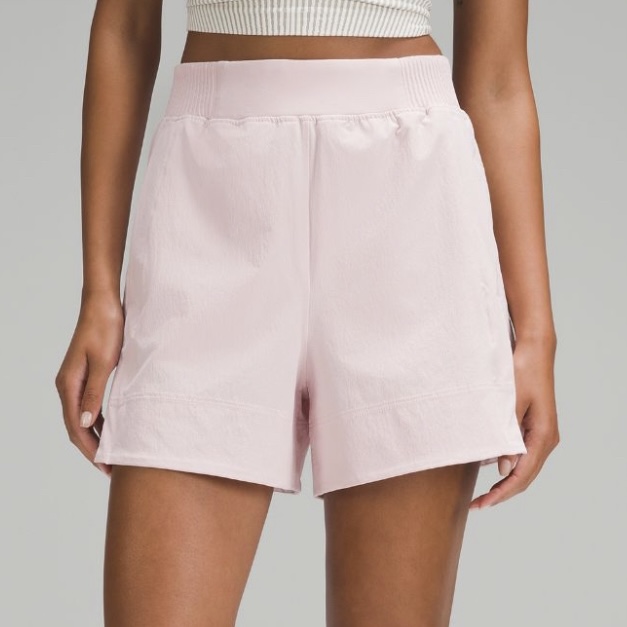 link to lululemon stretch woven relaxed-fit high-rise 4" shorts in the color flush pink