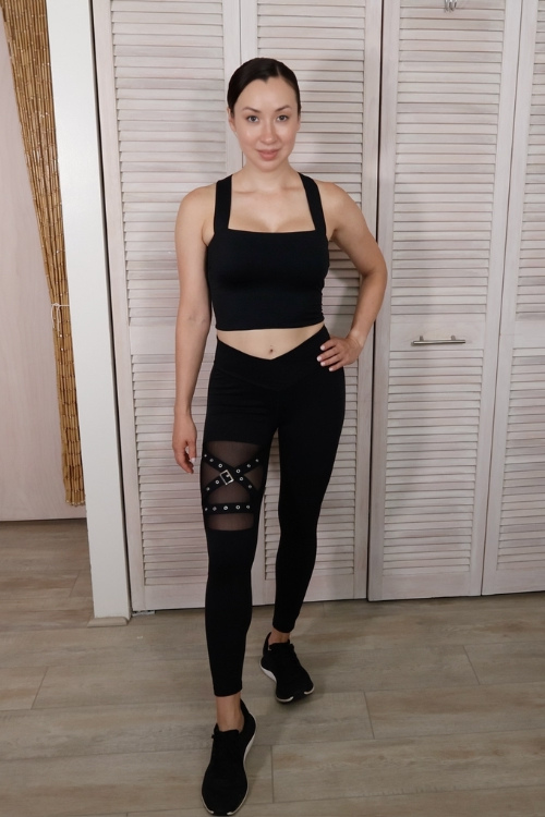 Front view of Esther wearing Crossover Buckle Leggings and Lace-Up Crop Tank 